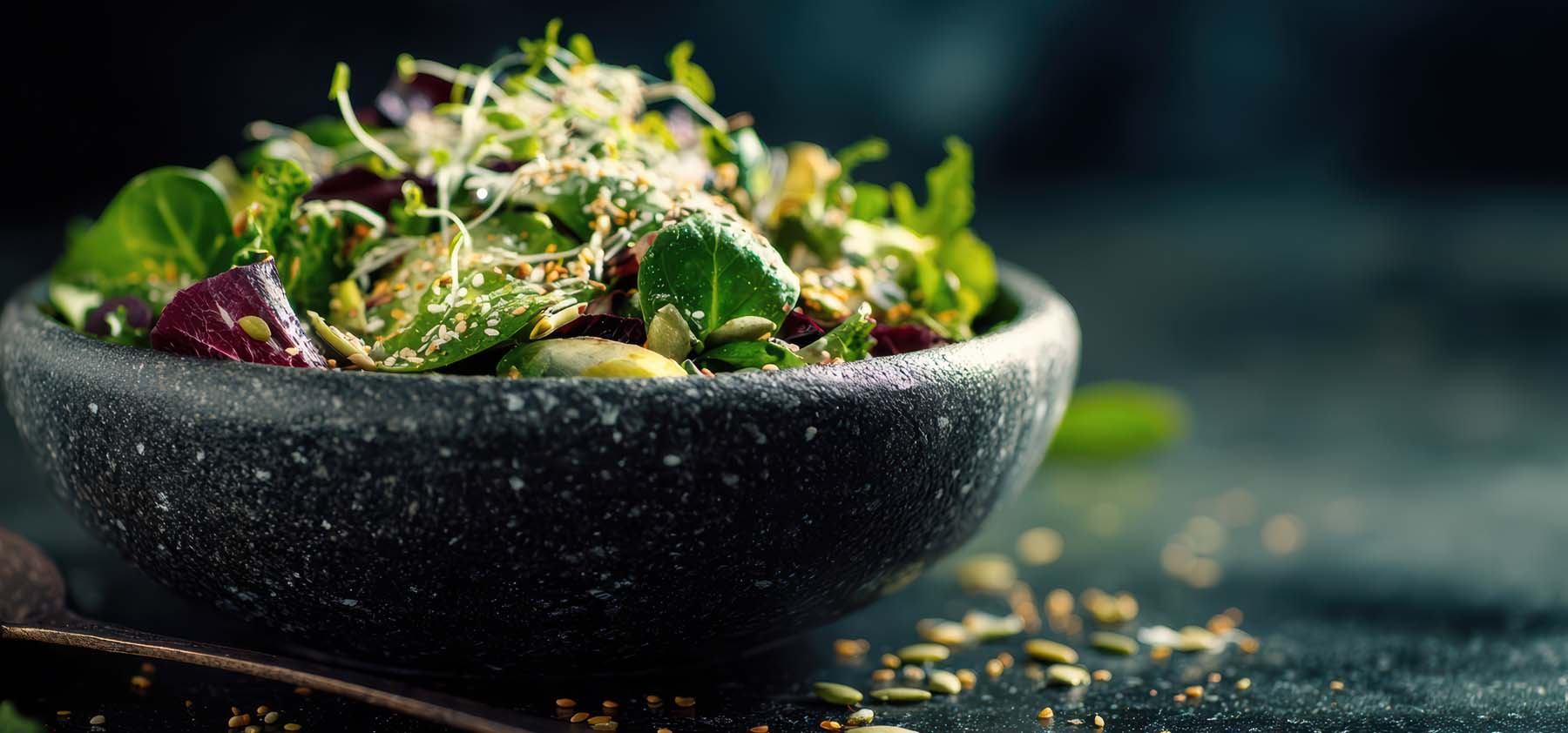 A vibrant dark green fresh salad bowl topped with sprouts and seeds for natural wellness